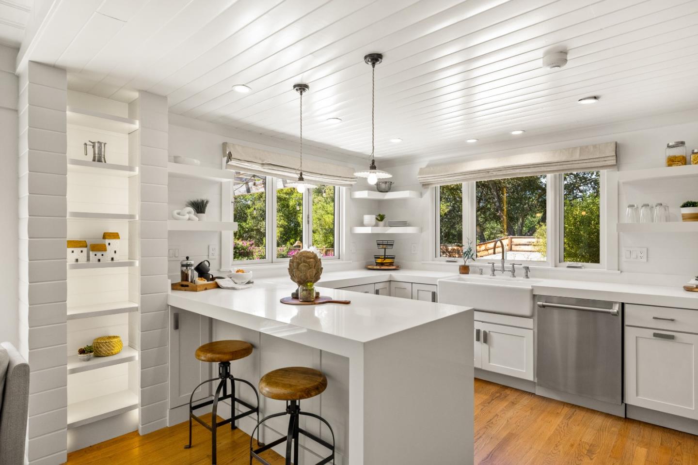58 La Rancheria Carmel Valley, CA 93924 - Photo 9 of 36 a kitchen with a sink a stove and chairs