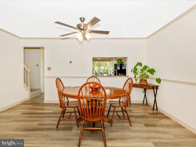 a view of a dining room with furniture and a chandelier