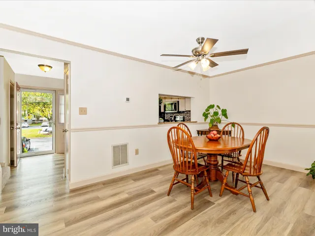 a view of a dining room with furniture and a window