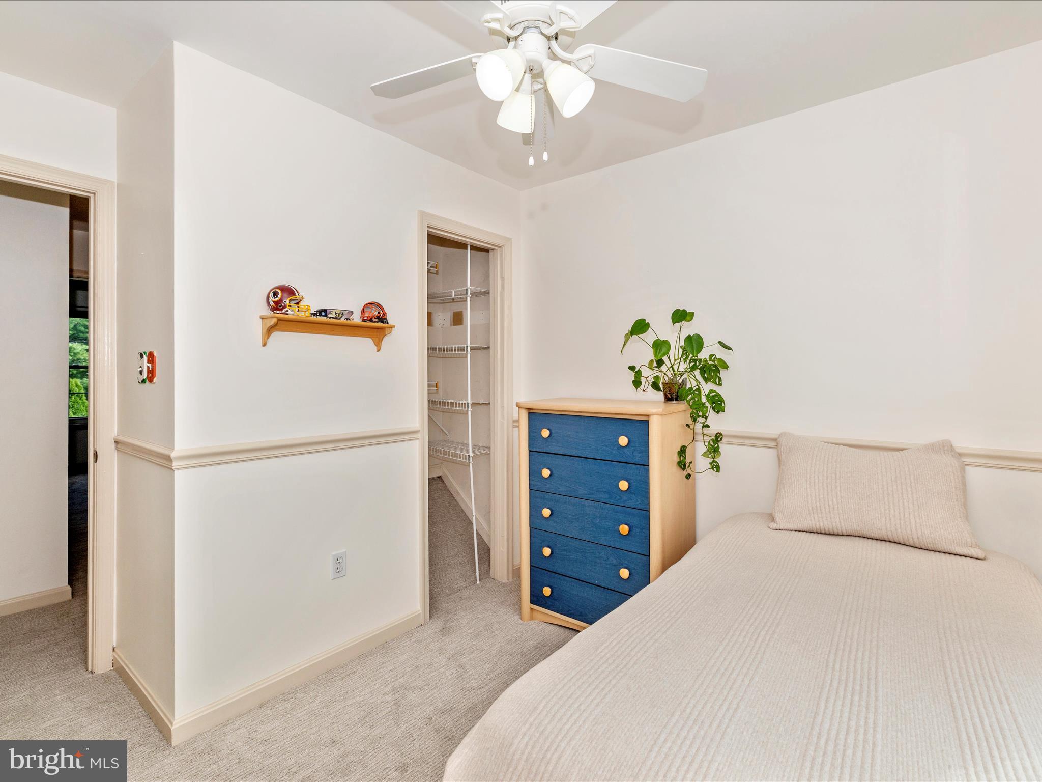 6739 Killdeer Court Frederick, MD 21703 - Photo 21 of 38 a bedroom with a bed and a chandelier