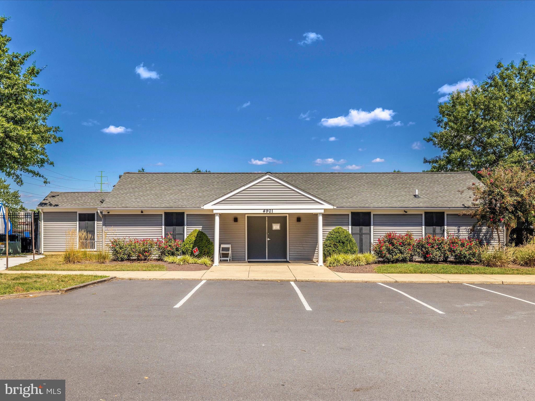 6739 Killdeer Court Frederick, MD 21703 - Photo 35 of 38 a front view of a building with a garden and yard