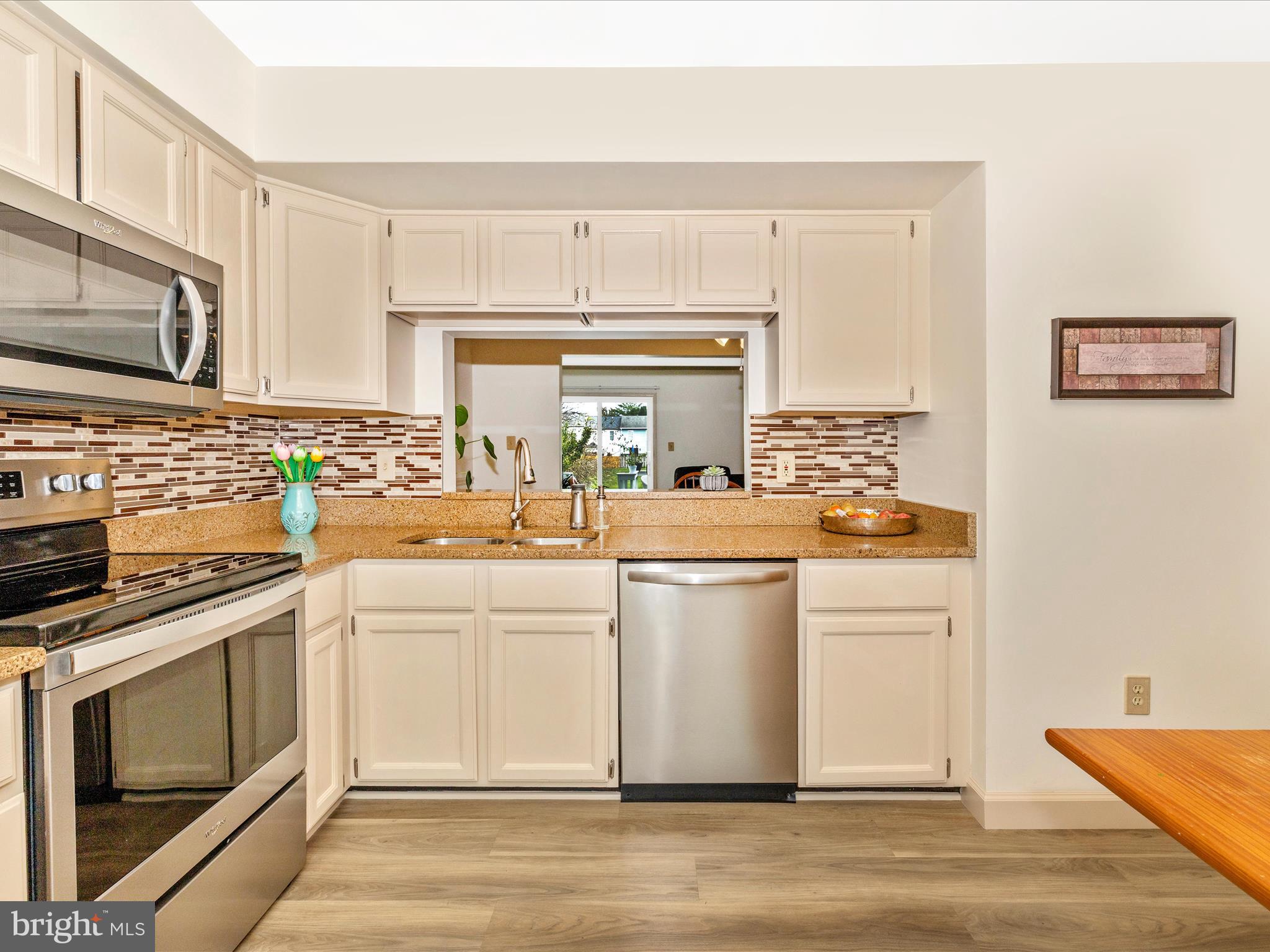 6739 Killdeer Court Frederick, MD 21703 - Photo 8 of 38 a kitchen with white cabinets and appliances