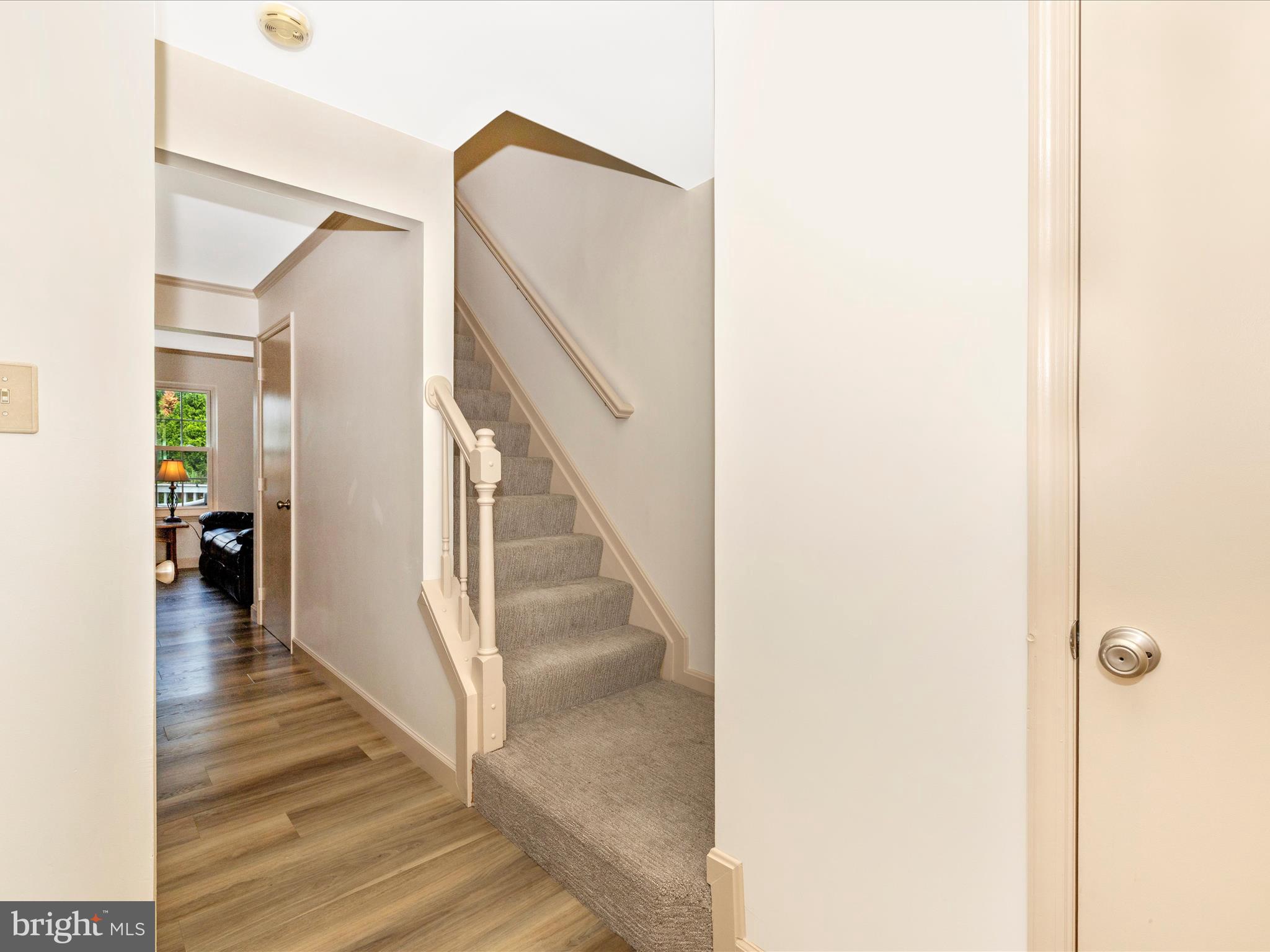 6739 Killdeer Court Frederick, MD 21703 - Photo 10 of 38 a view of a hallway with wooden floor and staircase