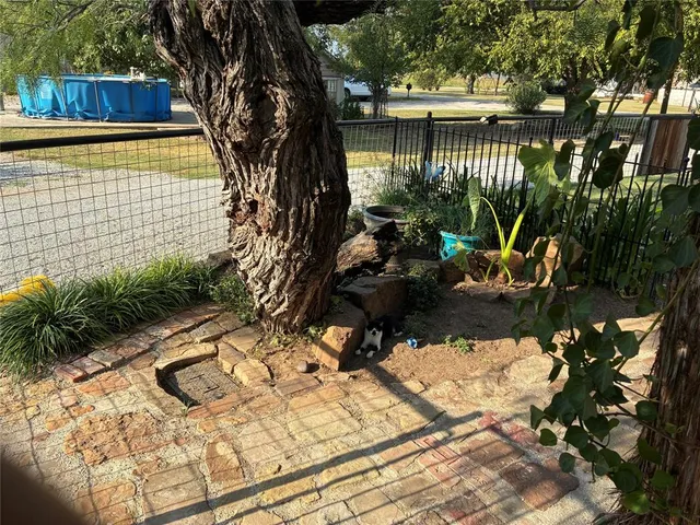 a backyard of a house with table and chairs