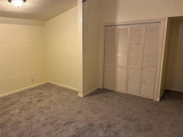 an empty room with closet area
