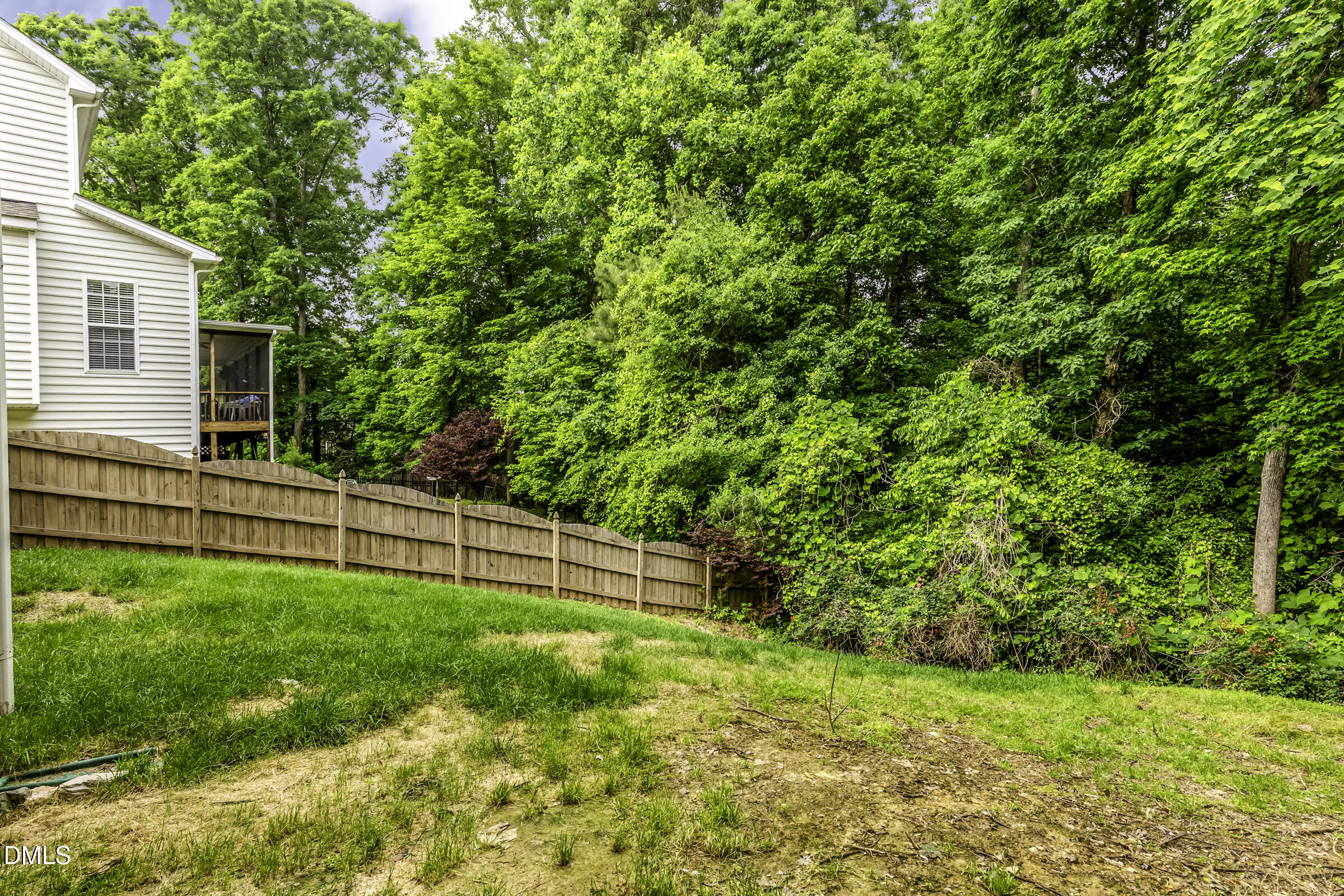201 Quarryrock Road Holly Springs, NC 27540 - Photo 4 of 34 a view of a backyard with plants and large trees