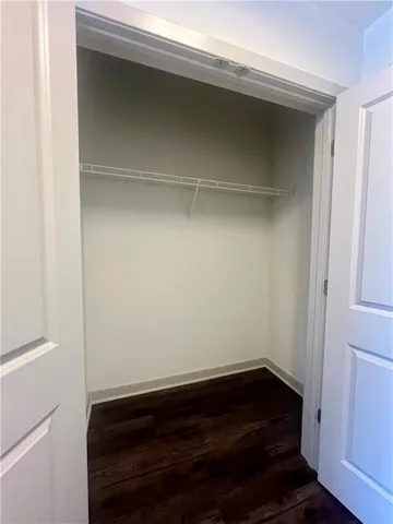 a room with wooden floor and a window