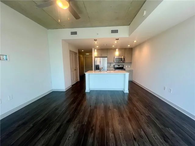 a large kitchen with a table and chairs