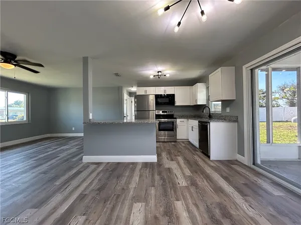 a kitchen with granite countertop a stove and a refrigerator