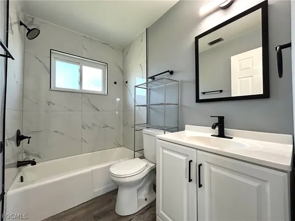 a bathroom with a sink a toilet and bathtub