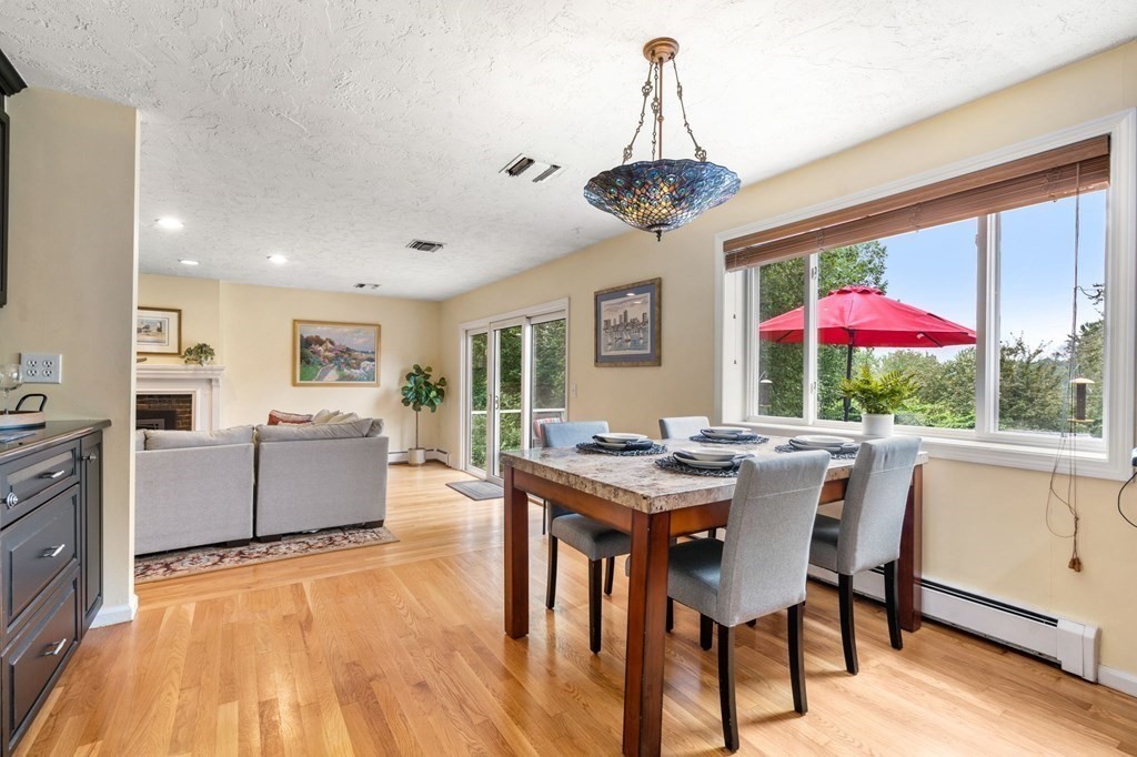 96 Bridge Street Medfield, MA 02052 - Photo 11 of 41 a dining room with furniture a kitchen and a chandelier