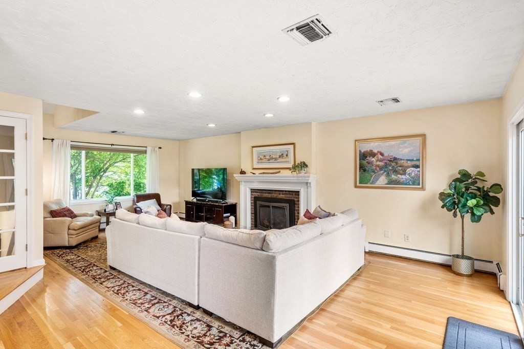 96 Bridge Street Medfield, MA 02052 - Photo 12 of 41 a living room with furniture a fireplace and a potted plant