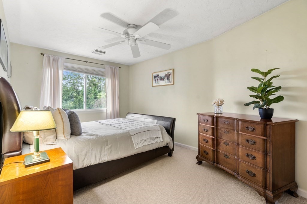 96 Bridge Street Medfield, MA 02052 - Photo 23 of 41 a bedroom with a bed potted plant with the dresser and mirror