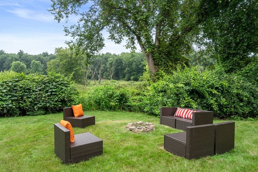 96 Bridge Street Medfield, MA 02052 - Photo 36 of 41 a backyard of a house with table and chairs