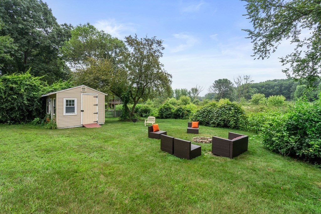 96 Bridge Street Medfield, MA 02052 - Photo 37 of 41 a backyard of a house with oven and wooden fence