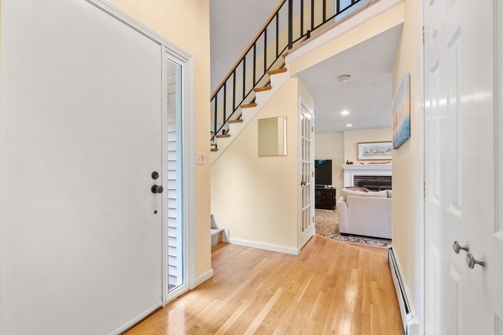 96 Bridge Street Medfield, MA 02052 - Photo 4 of 41 a view of a hallway with wooden floor and staircase