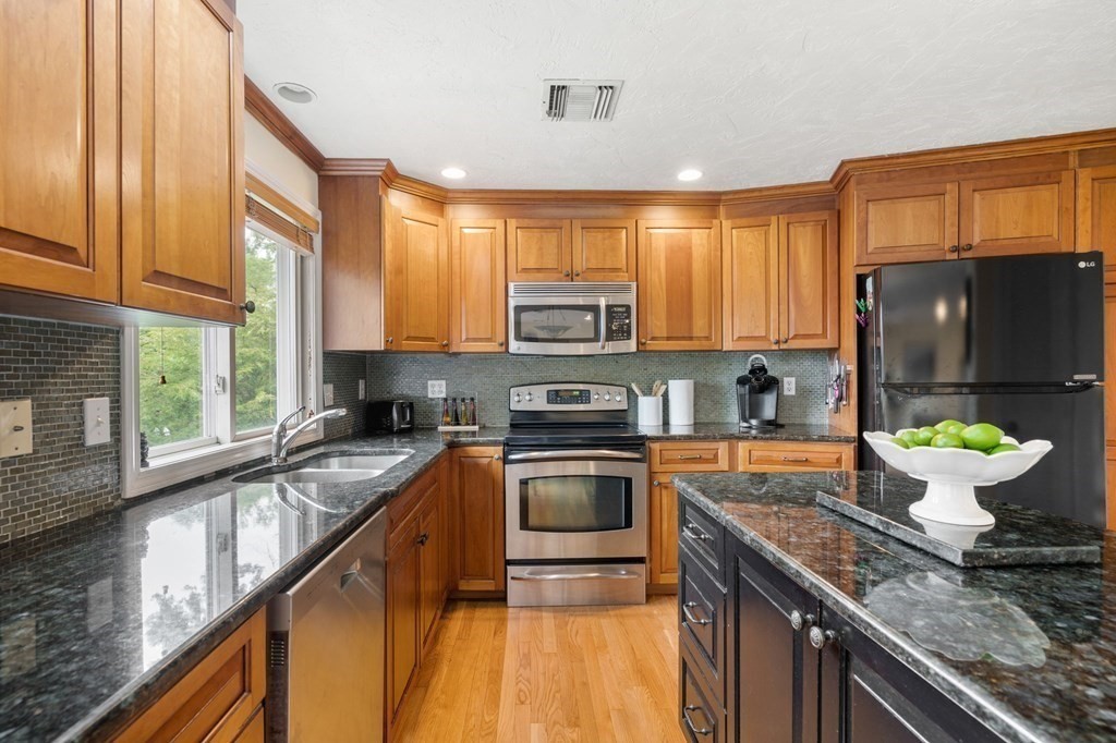 96 Bridge Street Medfield, MA 02052 - Photo 7 of 41 a kitchen with a stove a sink and a microwave