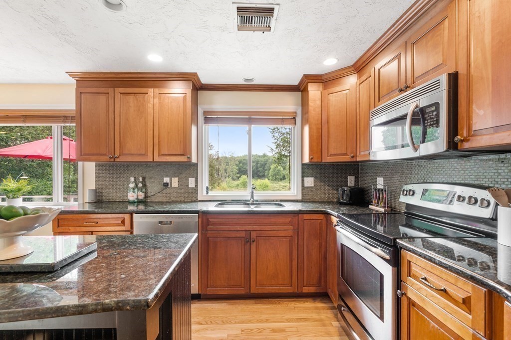 96 Bridge Street Medfield, MA 02052 - Photo 8 of 41 a kitchen with stainless steel appliances granite countertop a sink stove and cabinets
