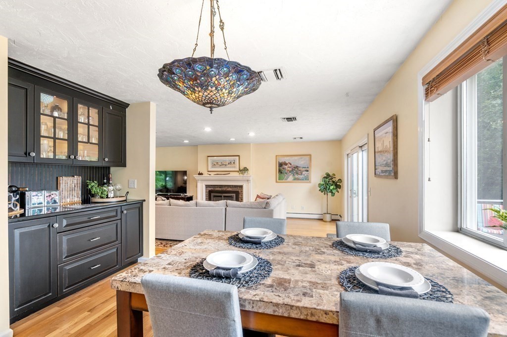96 Bridge Street Medfield, MA 02052 - Photo 10 of 41 a view of a dining room with furniture a kitchen and chandelier