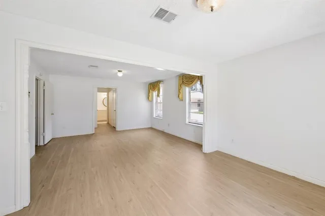 a view of a livingroom with wooden floor and window