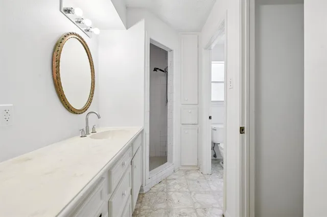 a spacious bathroom with a sink and a mirror