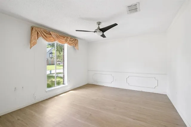 an empty room with windows and white walls