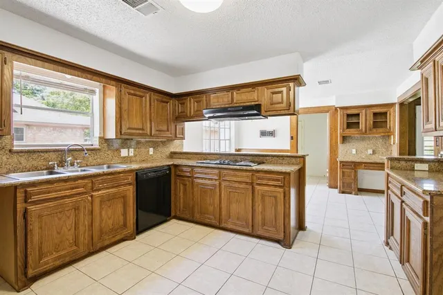 a kitchen with stainless steel appliances granite countertop a stove sink and cabinets