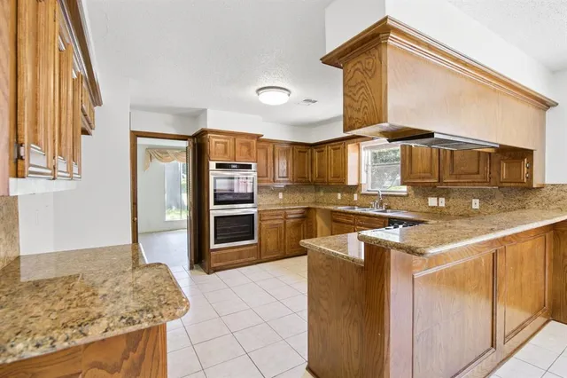 a kitchen with stainless steel appliances granite countertop a stove and a sink