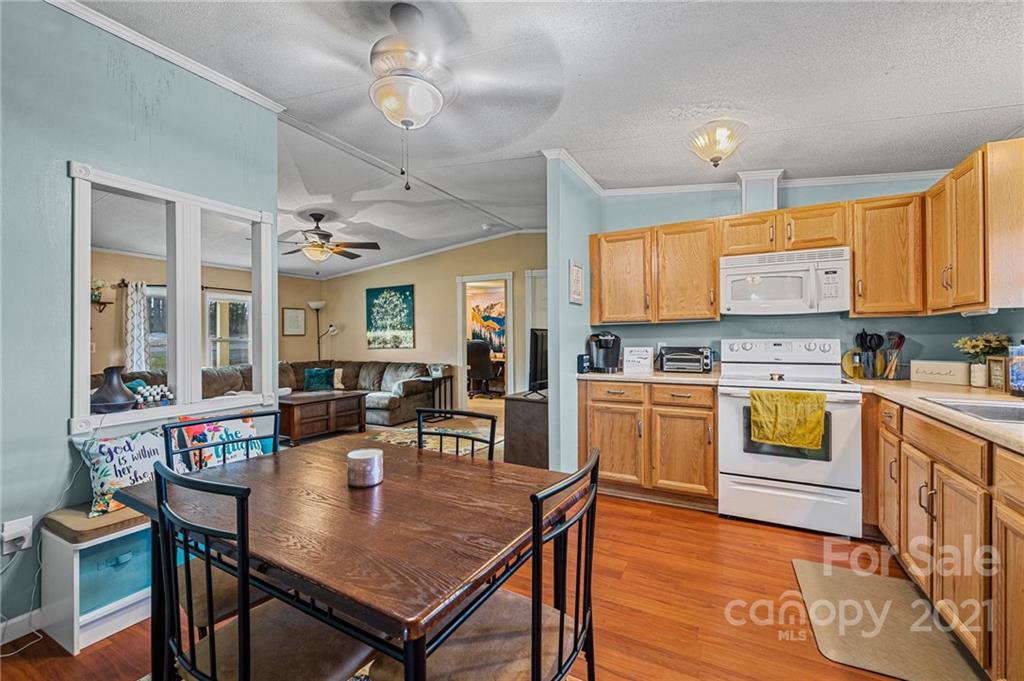 4507 Morgan Mill Road Monroe, NC 28110 - Photo 14 of 33 a kitchen with a table chairs stove and cabinets