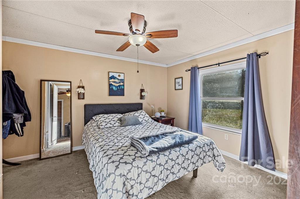 4507 Morgan Mill Road Monroe, NC 28110 - Photo 16 of 33 a bedroom with a large bed and a window