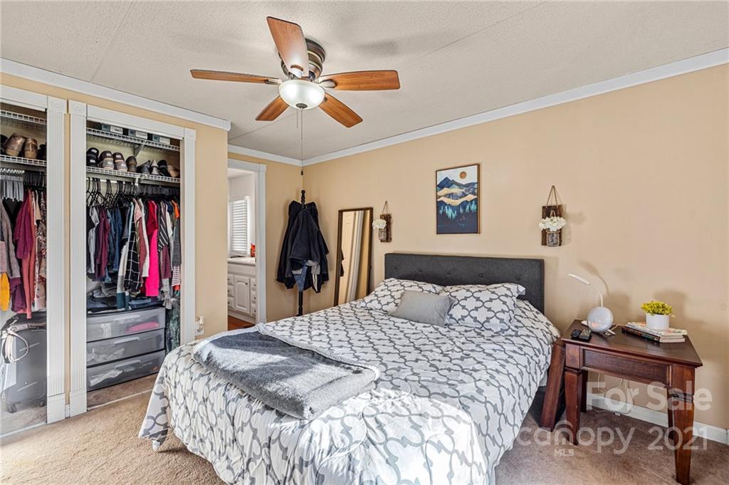 4507 Morgan Mill Road Monroe, NC 28110 - Photo 18 of 33 a bedroom with a bed and a chandelier