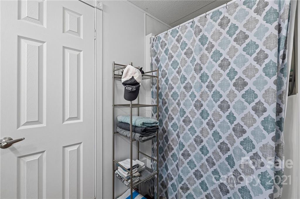 4507 Morgan Mill Road Monroe, NC 28110 - Photo 19 of 33 a bathroom with a shower curtain and a sink