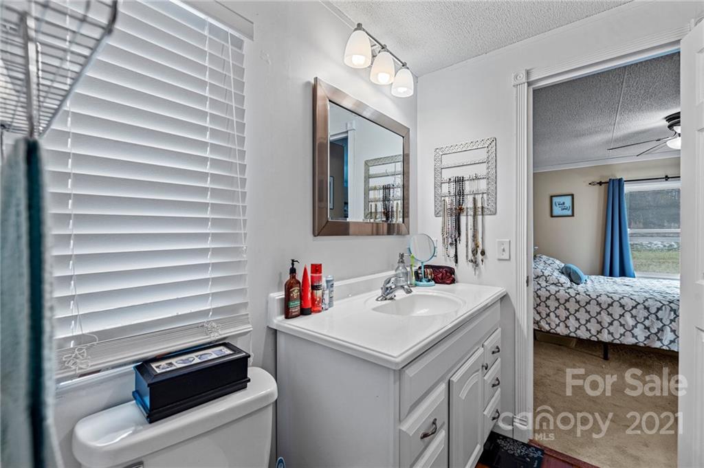 4507 Morgan Mill Road Monroe, NC 28110 - Photo 20 of 33 a bathroom with a sink and a mirror