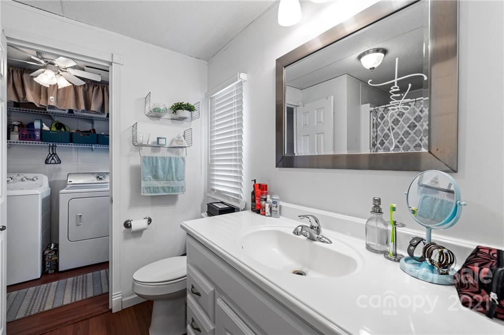 4507 Morgan Mill Road Monroe, NC 28110 - Photo 21 of 33 a bathroom with a sink toilet and mirror