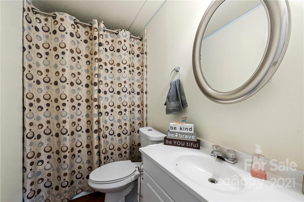 4507 Morgan Mill Road Monroe, NC 28110 - Photo 26 of 33 a bathroom with a sink toilet and a mirror