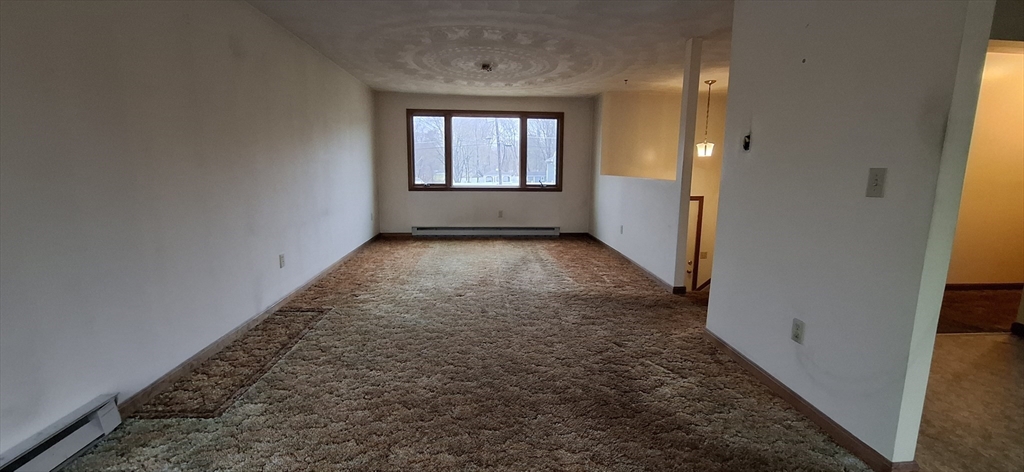 32 3rd Street Webster, MA 01570 - Photo 3 of 13 wooden floor in an empty room with a window