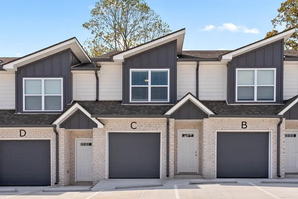 a front view of a house with garage