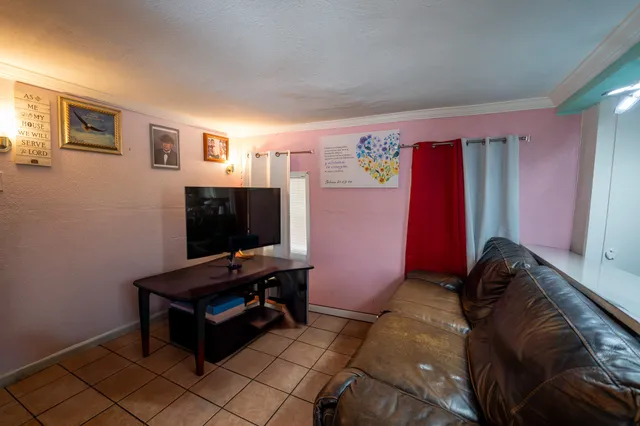 a bedroom with furniture and a flat screen tv