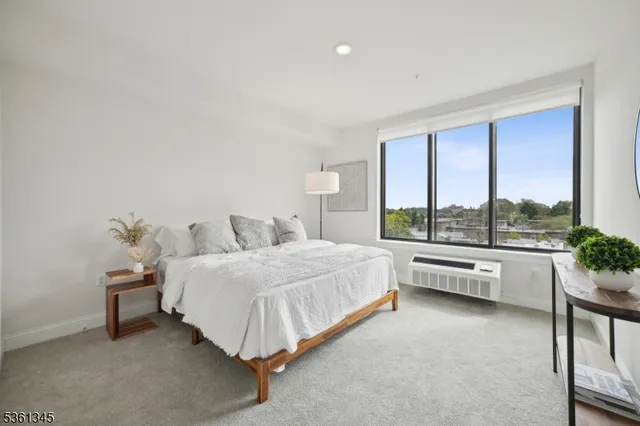 a bed room with a bed and a large window