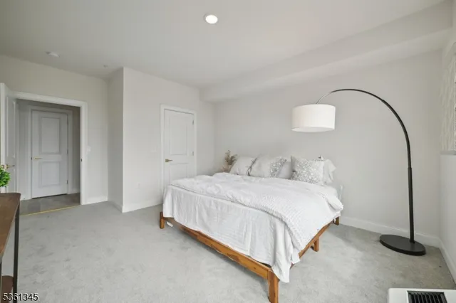 a bedroom with a bed and a lamp