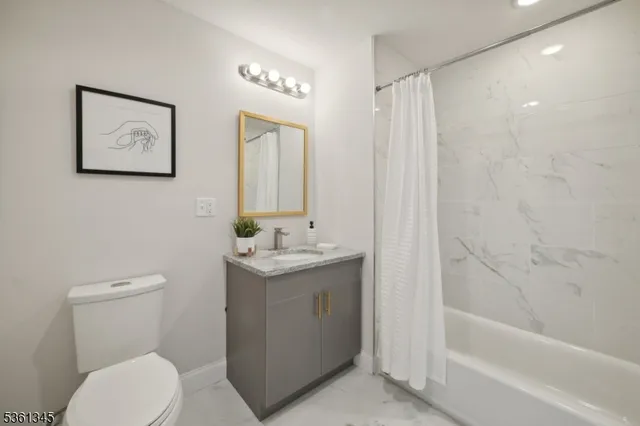 a bathroom with a toilet a sink and bathtub