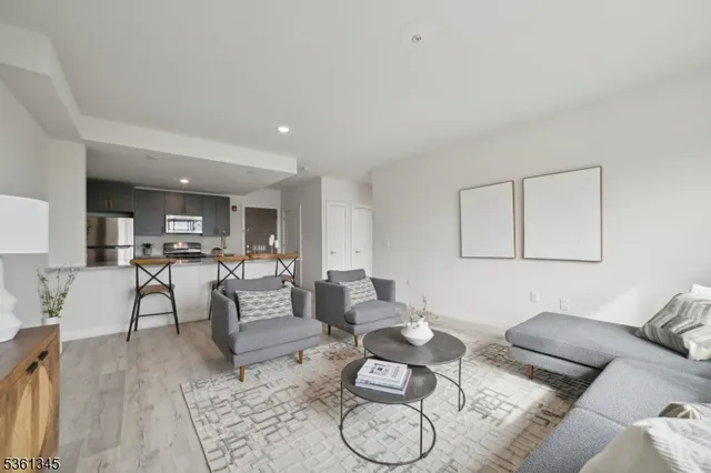 a living room with furniture and kitchen view