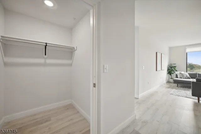 a view of a livingroom with wooden floor a fireplace and windows