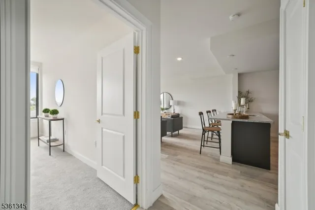 a view of a hallway with couch and wooden floor