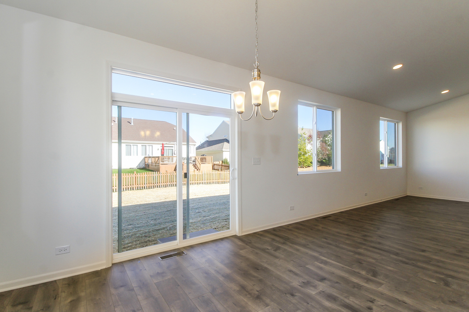 2080 Brandon Hill Road New Lenox, IL 60451 - Photo 8 of 15 an empty room with wooden floor mirror and windows