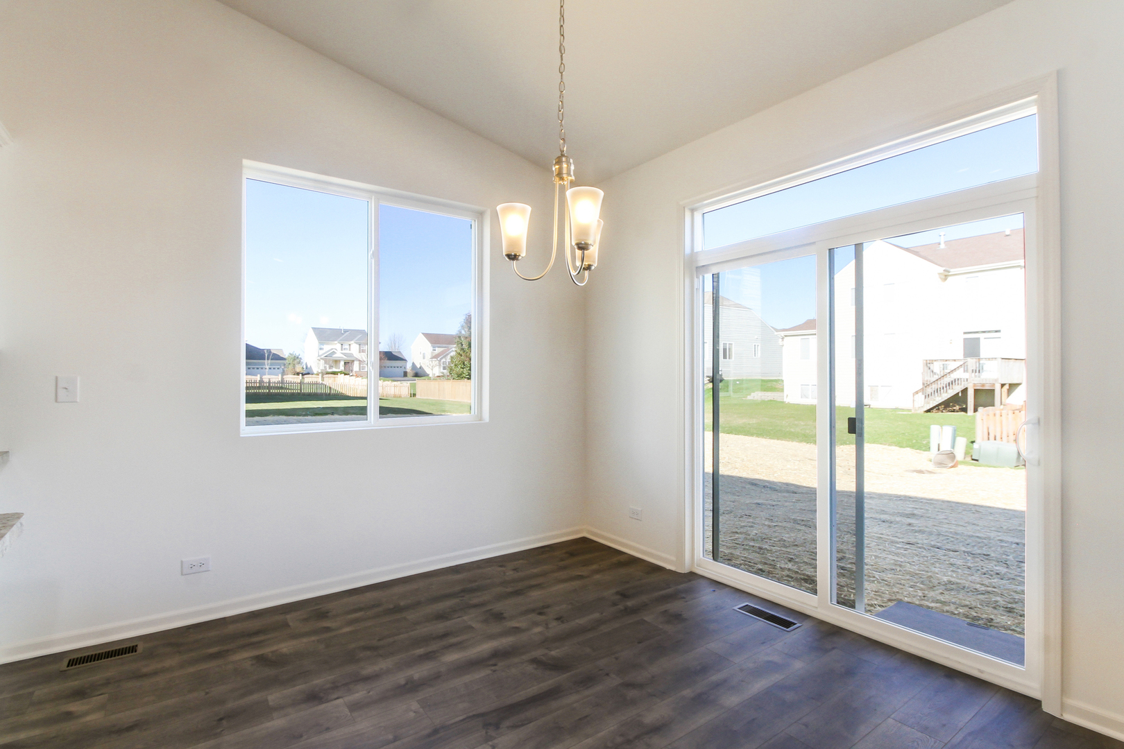 2080 Brandon Hill Road New Lenox, IL 60451 - Photo 9 of 15 a view of an empty room with wooden floor and windows
