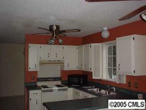 5823 Rimerton Drive Charlotte, NC 28226 - Photo 2 of 8 a kitchen with a sink and a stove top oven