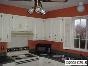 5823 Rimerton Drive Charlotte, NC 28226 - Photo 5 of 8 a kitchen with stainless steel appliances a stove and white cabinets