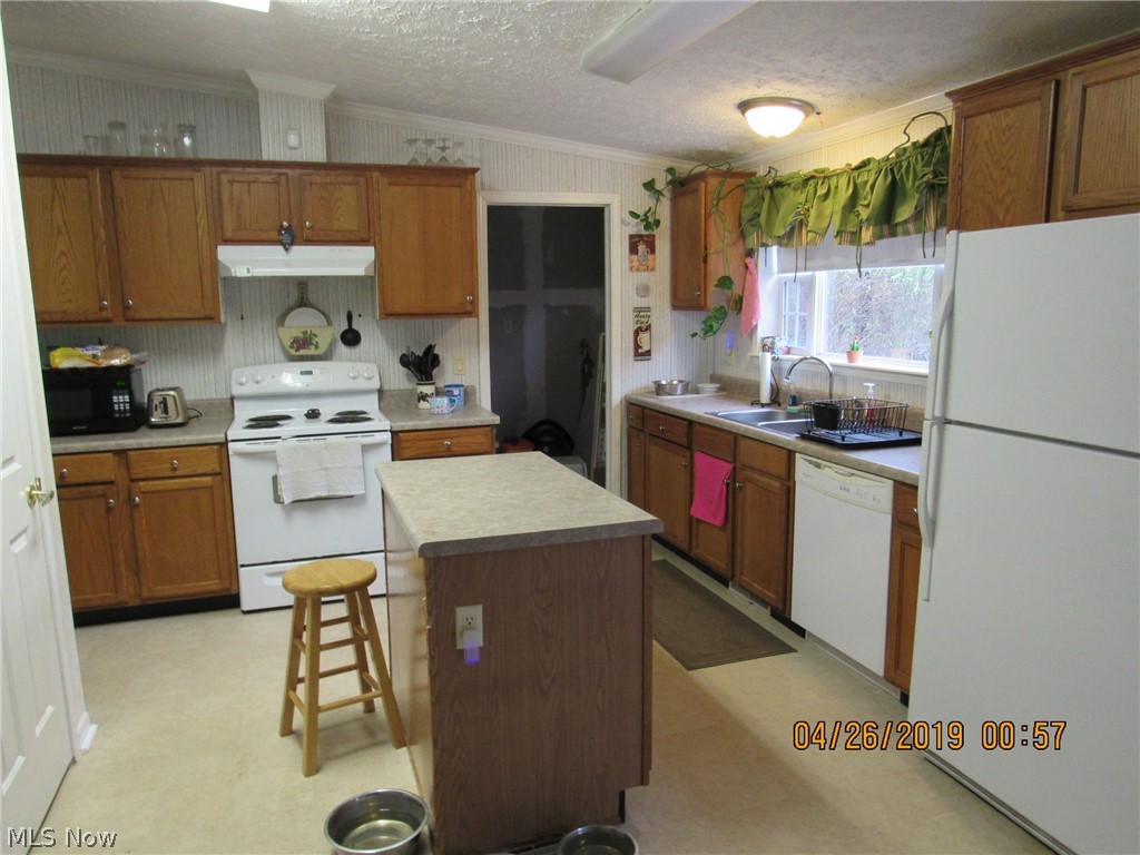 4502 Tower Road Dorset, OH 44032 - Photo 3 of 16 BIG, well lit kitchen featuring all appliances, ample counter and cabinet space including a pantry cupboard and island w/electric!