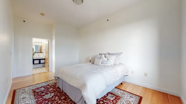 a view of an empty room with wooden floor